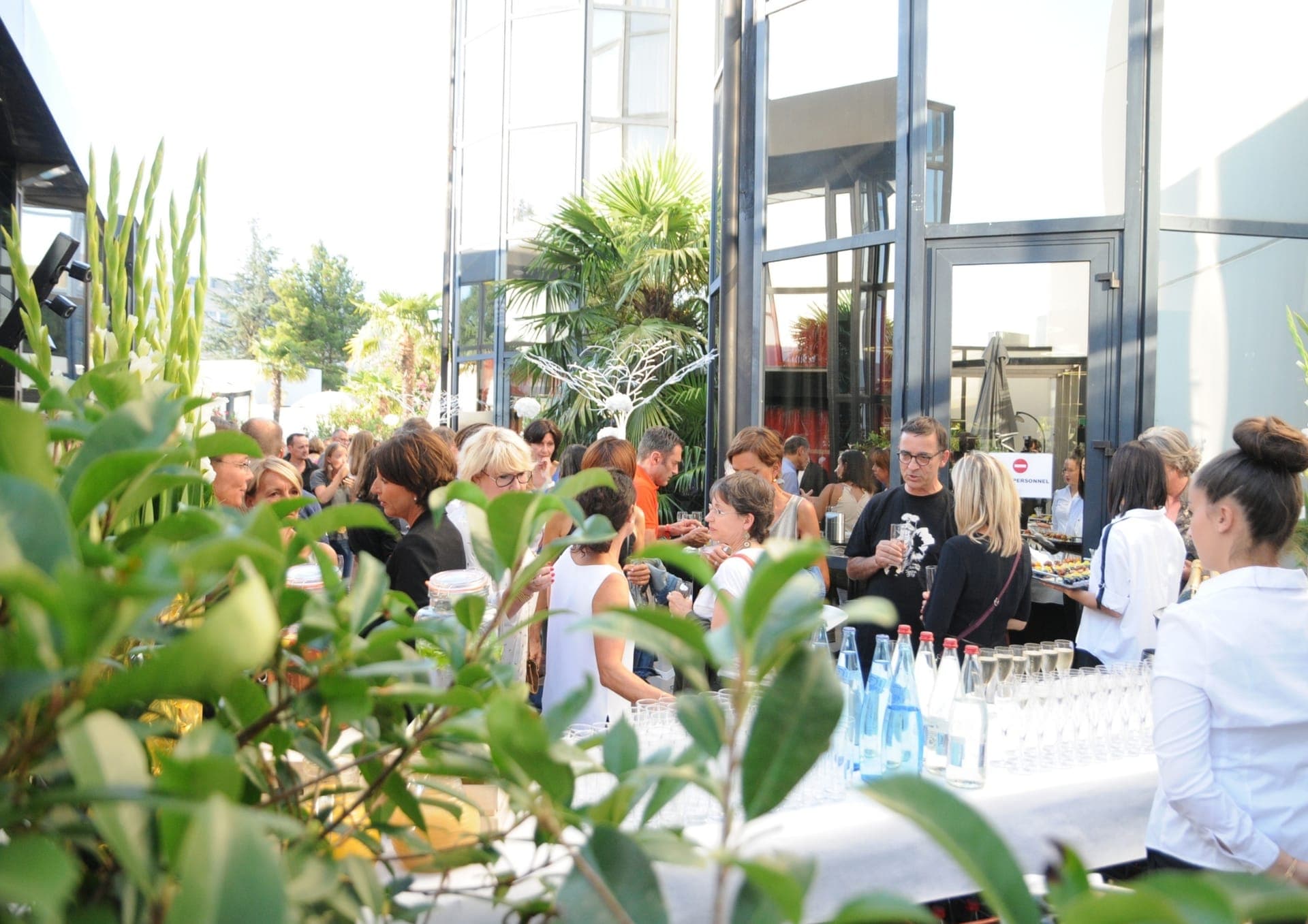 Colleagues enjoying a sociable moment on the terrace of the Hôtel Palladia